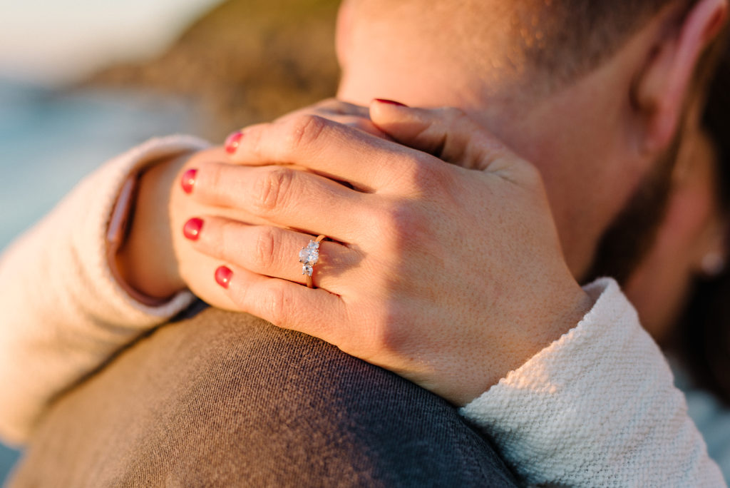 Sunshines through a engagement ring at this San Diego Proposal Photoshoot. 