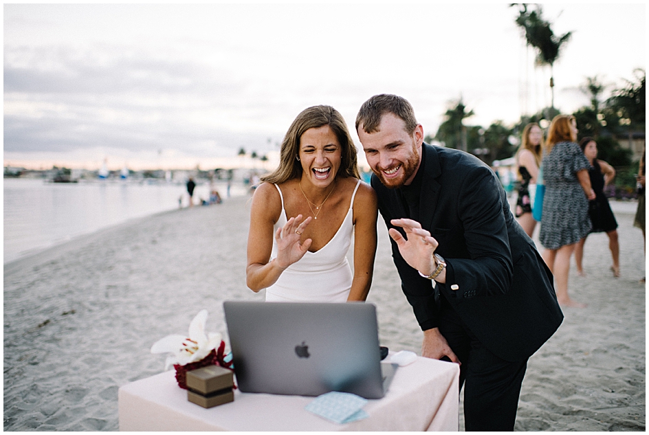 To get married in the time of Corona means needing to Livestream the Ceremony to friends and family afar using a laptop.  The bride and groom wave hello to their live-streamed guests. 