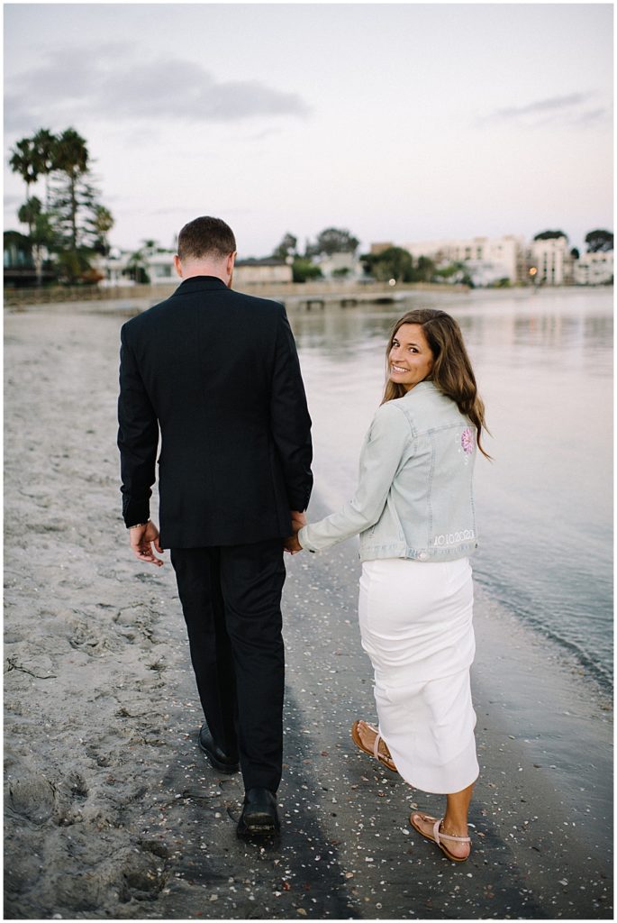 San Diego elopement photographer Marie Monforte captures this man and woman's Microwedding on the beach walking distance from their Pacific beach home.