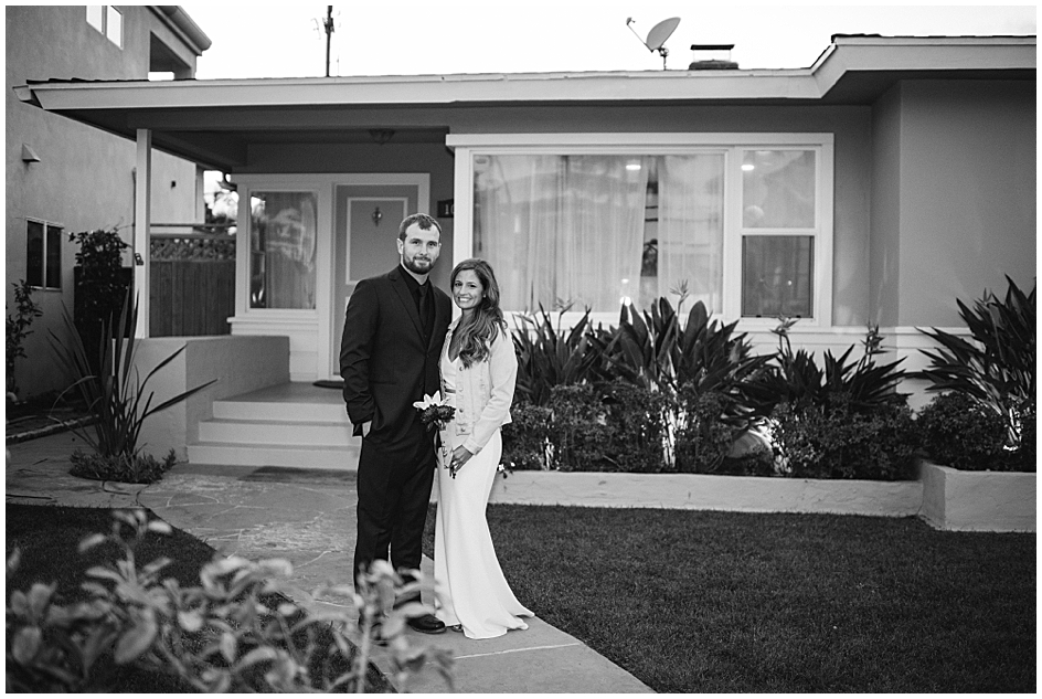 The bride and groom pose outside the AirBnB they rented for the Mircrowedding reception dinner. Captured by San Diego Elopement Photographer Marie Monforte. 