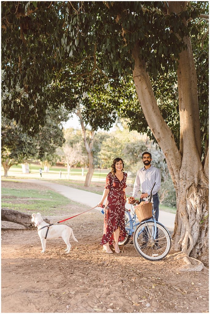 Balboa Park is the perfect place for a picnic in the park engagement session.  This couple brought their bike, and their dog and parked under a tree. 
