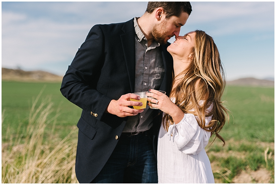 Newly engaged Man and Woman cheers with mimosas after his hot air balloon proposal by San Diego Wedding Photographer Marie Monforte. 